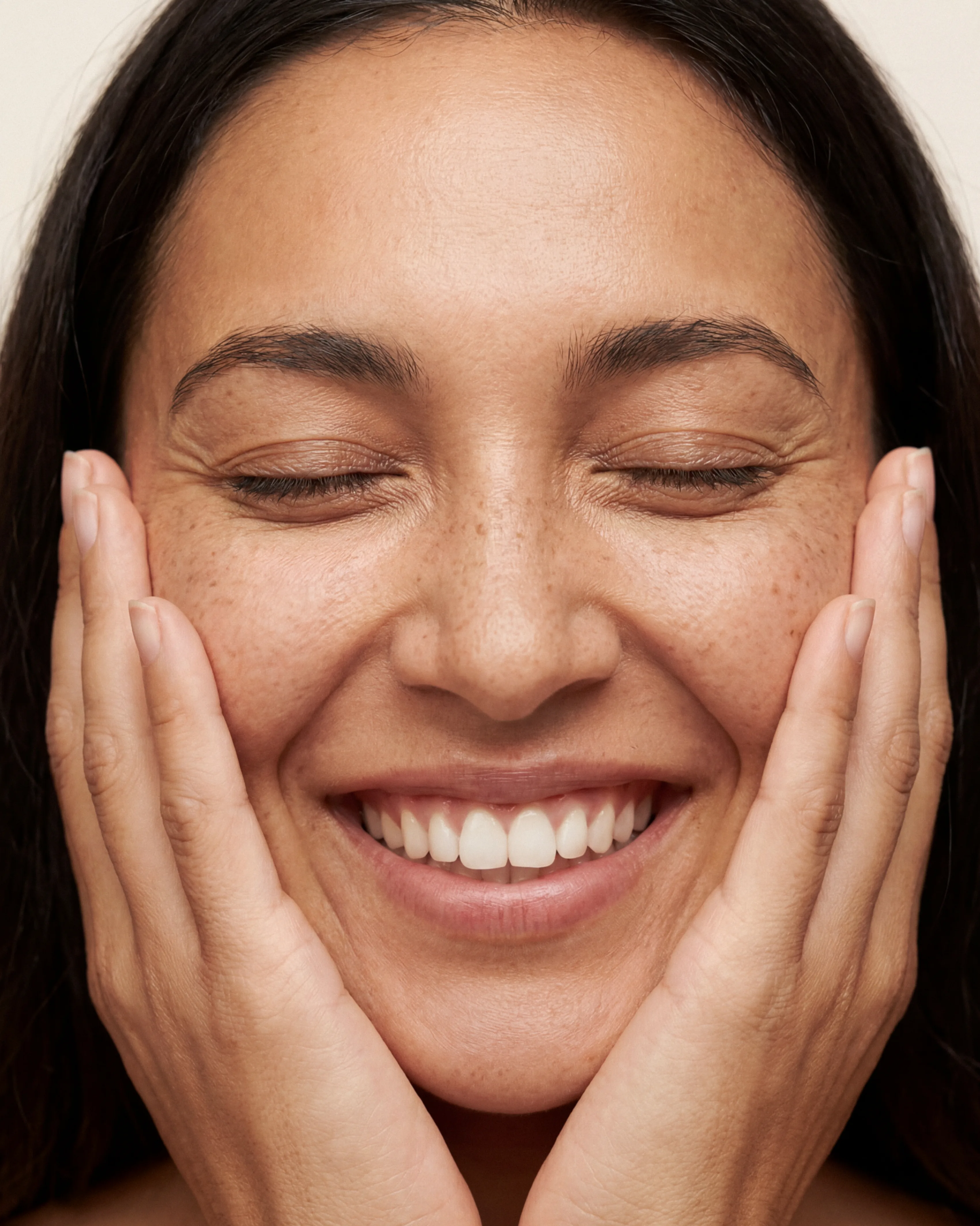 Smiling woman with her hands on her face, from the e-LINE photography direction