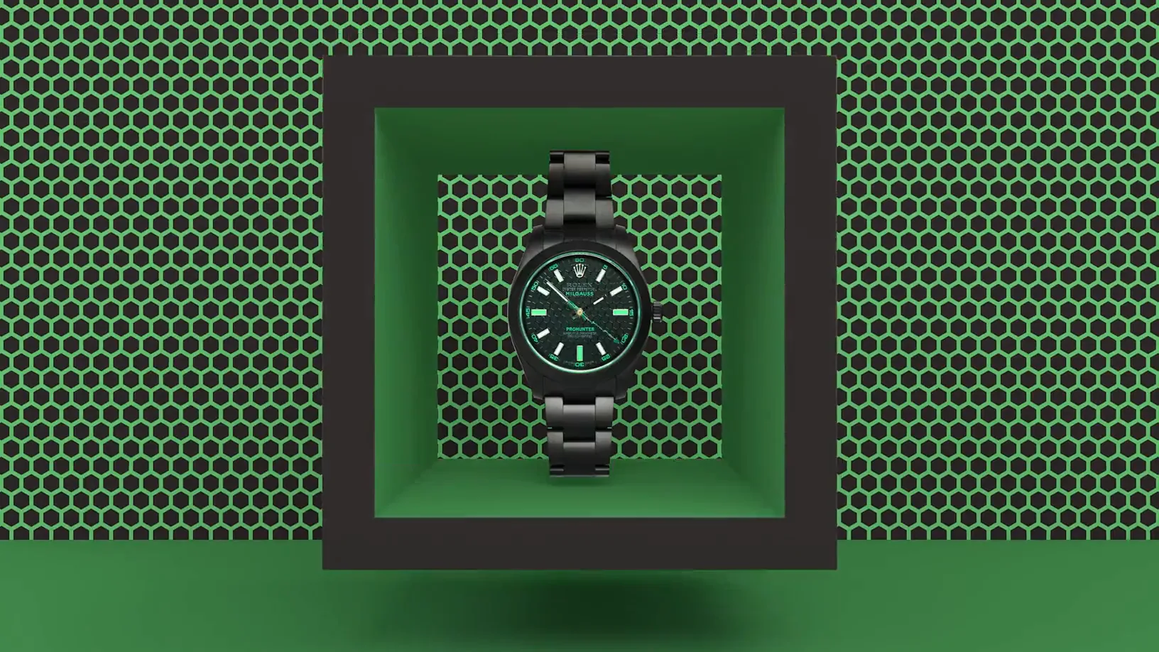 A black watch in a recess in perforated panels, the ground turning from red to green.