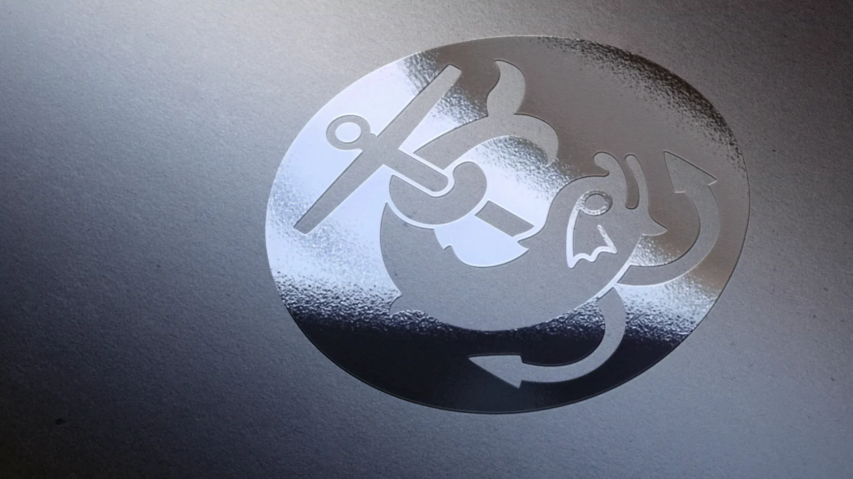 The IBC mark in mirrored foil on textured grey paper, under a sweep of light.